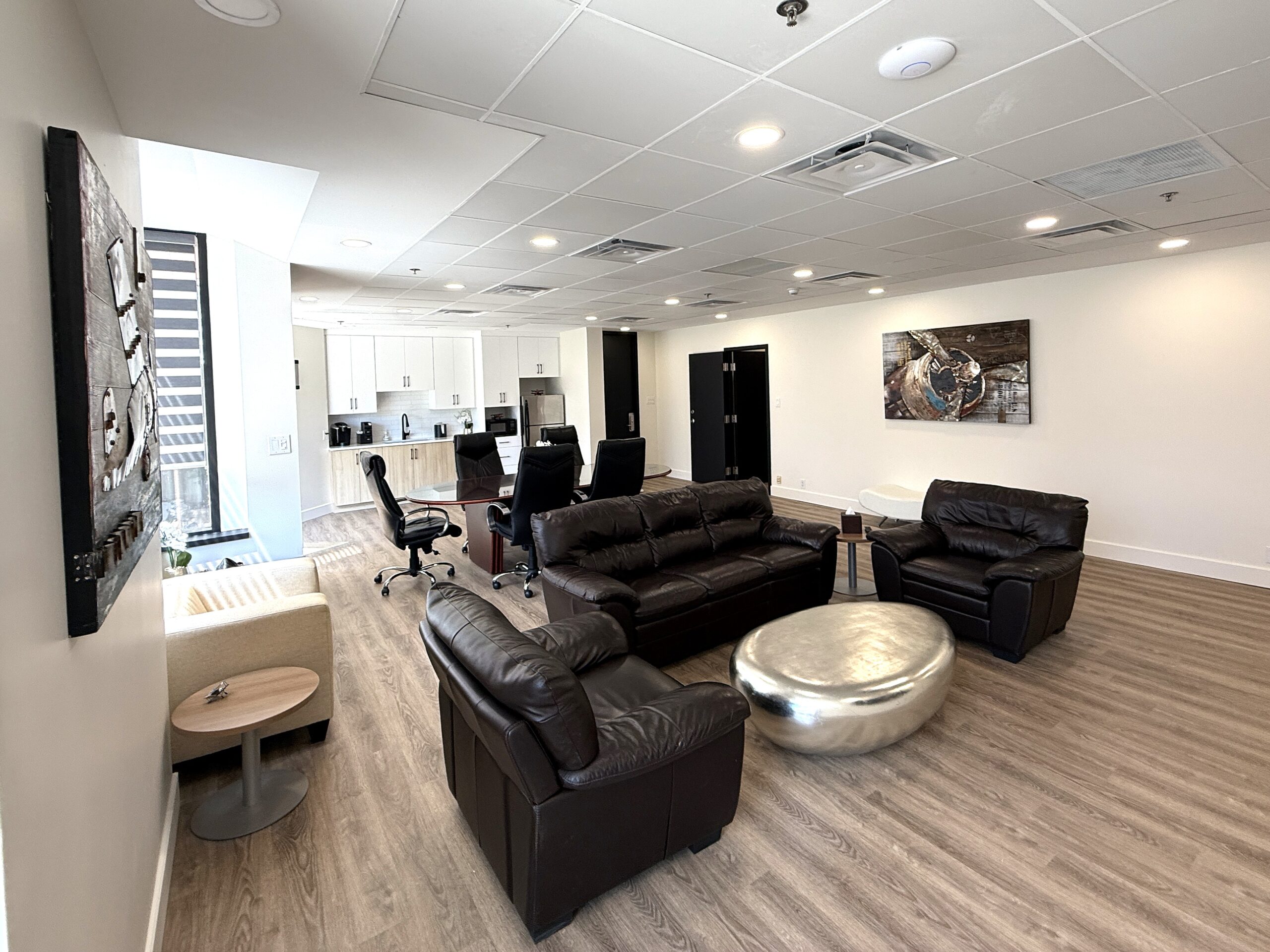 Spacious DEV Hotel team lounge with group seating and kitchenette